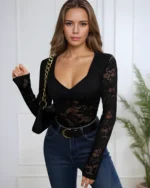 Woman wearing black floral lace bodysuit with blue jeans in casual home setting