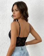Side view of black lace teddy bodysuit with high-waisted blue jeans