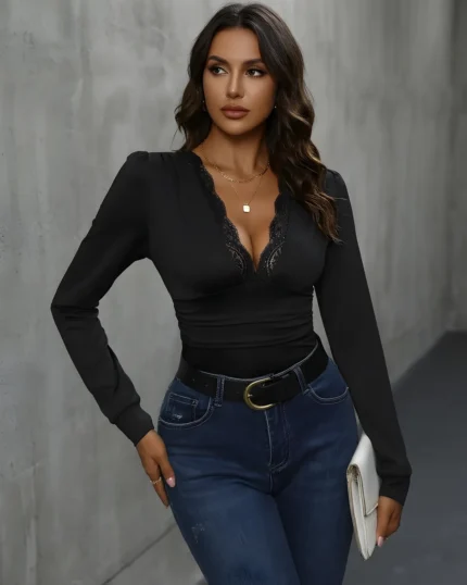 Front view of model wearing the black lace trim v neck bodysuit with blue jeans
