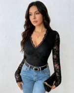 Front view of a black lace backless bodysuit styled with blue jeans