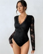 Front view of a model wearing a black lace backless bodysuit with a deep V-neck and long sleeves