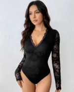 Front view of a model wearing a black lace open back bodysuit with long sheer sleeves and a deep V-neck