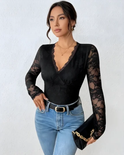 Front view of a long sleeve open back lace bodysuit styled with blue jeans