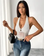 Woman wearing white lace halter bodysuit with blue jeans for casual chic outfit