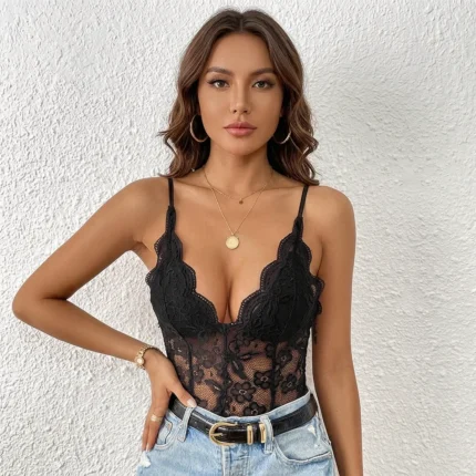 Woman wearing black deep V lace bodysuit with blue jeans front view