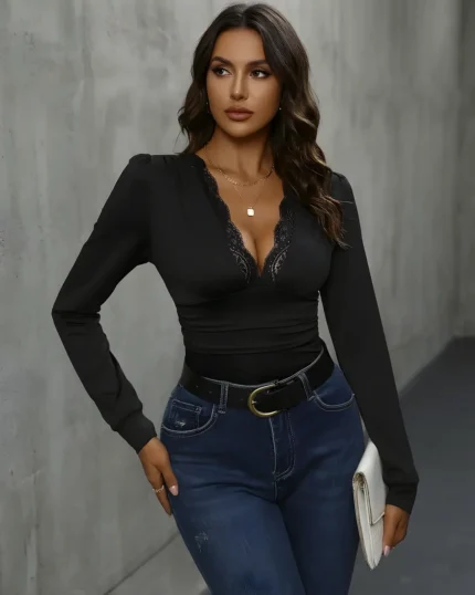 Front view of model wearing the black lace trim v neck bodysuit with blue jeans