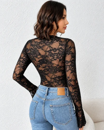 Back view of a black lace and mesh bodysuit paired with blue jeans