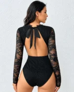 Back view of a black lace open back bodysuit showing the feminine bow tie detail