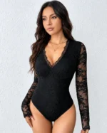 Front view of a model wearing a black lace open back bodysuit with long sheer sleeves and a deep V-neck