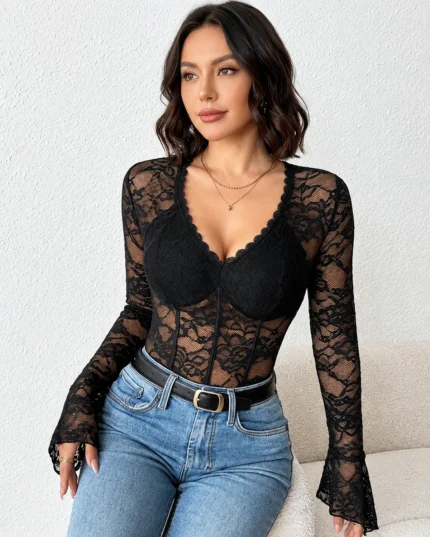 Front view of a black sheer lace long sleeve bodysuit styled with blue jeans