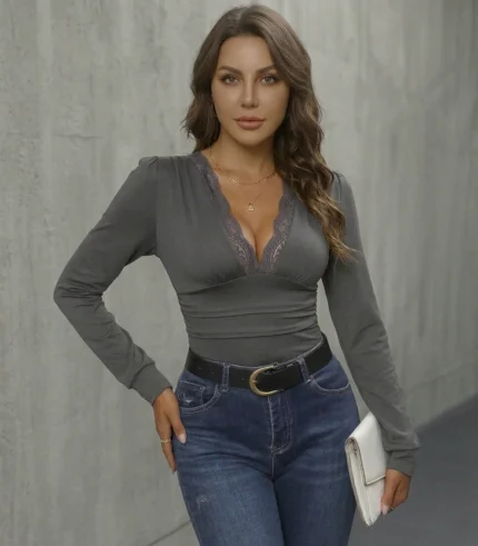 Woman wearing grey lace trimmed bodysuit with blue jeans as a going out top