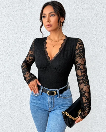 Front view of a long sleeve open back lace bodysuit styled with blue jeans